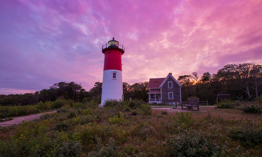 A lighthouse in Cape Cod at sunset.