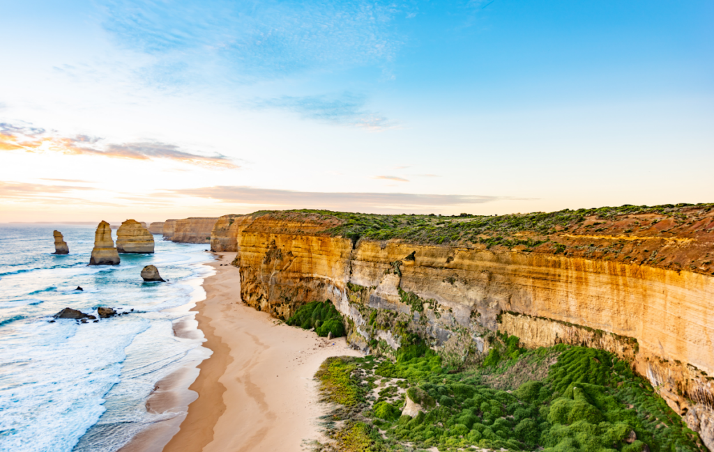 sandy beach butting up to rock cliffs